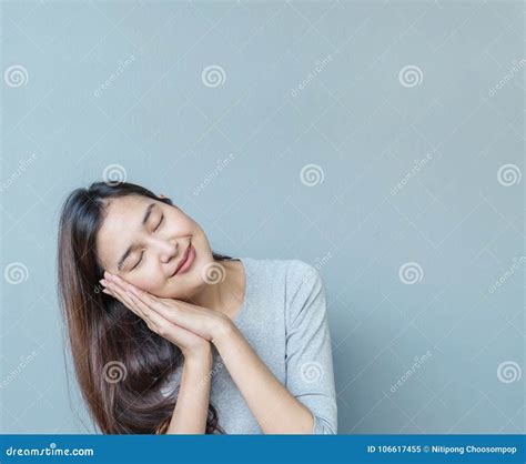 Closeup Asian Woman In Sleeping Action With Sweet Dream On Blurred Cement Wall Textured