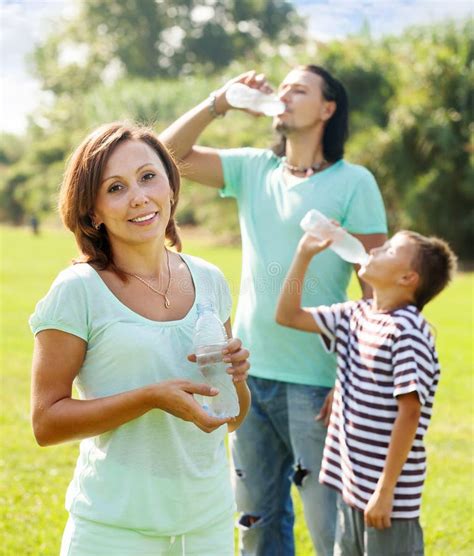 Happy Couple With Teenager Drinking From Bottles Stock Image Image Of Portrait Teen 35398615