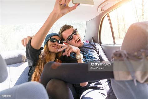 Couple On Backseat In Car Photographing Themselves Photo Getty Images