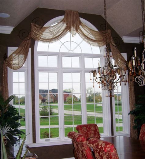 The beautiful tall arch windows were a real selling point when you bought the house. sheer arched swags | Arched window treatments, Custom ...