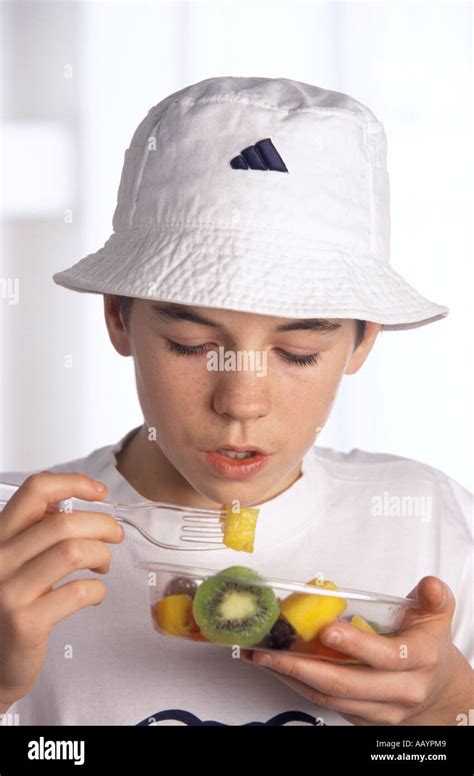 Teenage Boy Eating Salad Stock Photo Alamy
