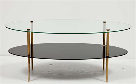 Two tier glass coffee tables are some of the furniture that you can truly admire not just for their beauty, but also for their contribution and impact in a home or office's interior design. Oval Glass Two-Tier Coffee Table at 1stdibs