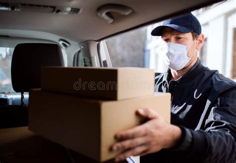 Delivery Man Delivering Parcel Box To Recipient Stock Photo Image Of