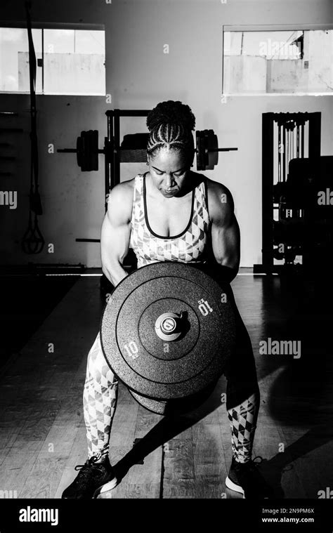 Muscular Woman Doing Exercises With Barbell In The Gym Crossfit