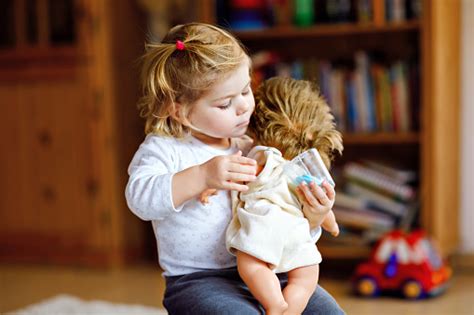 Adorable Cute Little Toddler Girl Playing With Doll Happy Healthy Baby