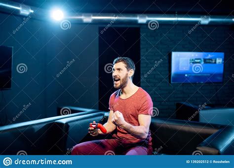 Happy Man Playing Video Games With Gaming Console In The Club Stock