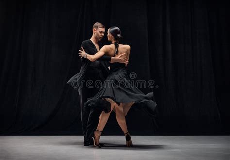 Romantic Couple Dance Man And Woman Professional Tango Dancers Performing In Black Stage
