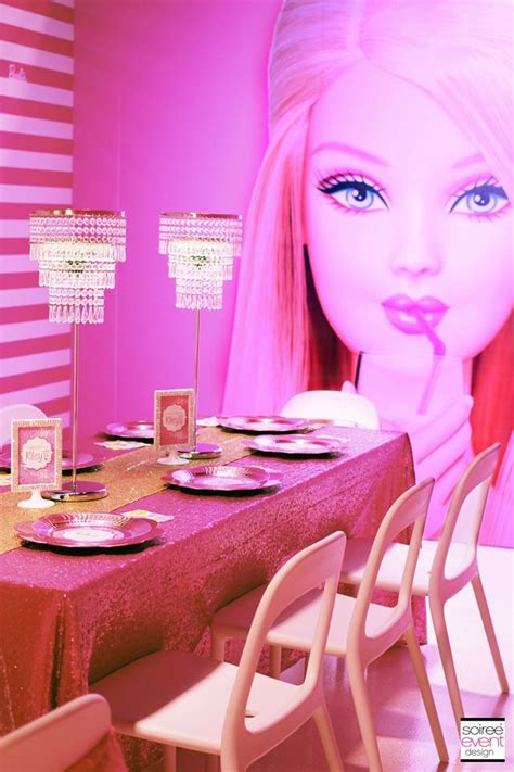 A Barbie Doll Sitting In Front Of A Table With Plates And Place Settings On It
