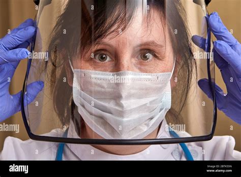 Serious Caucasian Female Doctor In Protective Uniform With Surgical