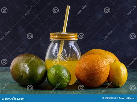 Front View Mango With Lemon Lime Orange And Juice In A Jar With A