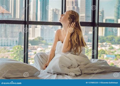 Woman Wakes Up In The Morning In An Apartment In The Downtown Area With