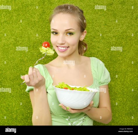Smiling Girl Eating Salad Stock Photo Alamy