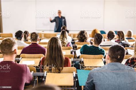 Rear View Of Large Group Of Students On A Class At Lecture Hall Stock