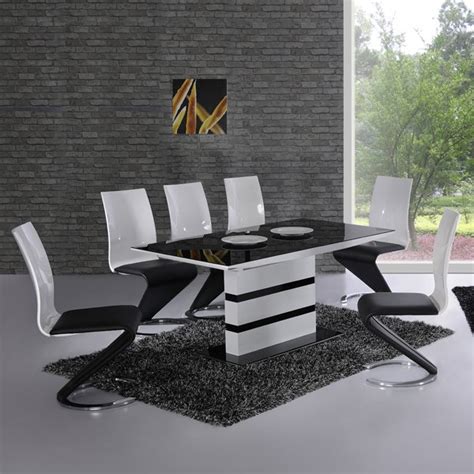 For a timeless look in the dining room, furnish the space with a black dining table. Arctica White Extending Black Glass Dining Table And 6