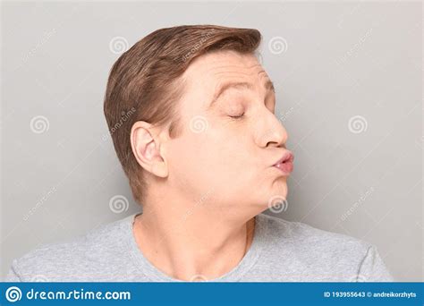 Portrait Of Funny Mature Man Pouting His Lips And Blowing Kiss Stock Image Image Of Duckface
