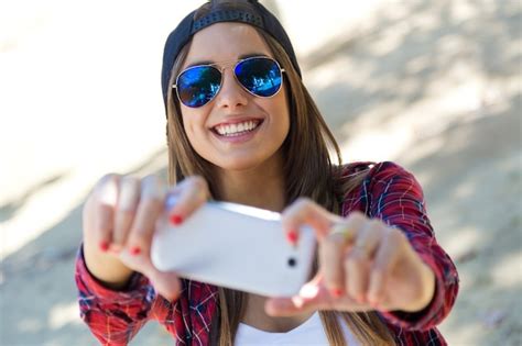 Portrait Of Beautiful Girl Taking A Selfie With Mobile Phone In Photo Free Download