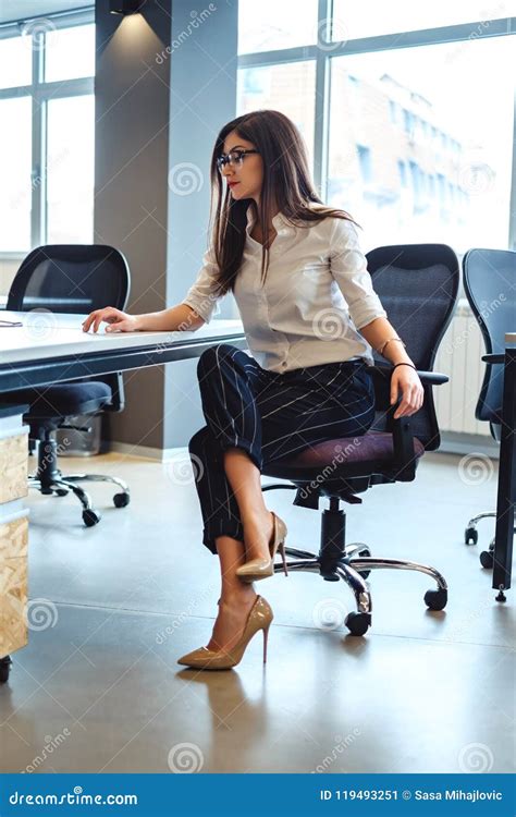 Serious Business Woman Sitting And Looking At The Desk Stock Image