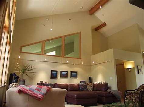 My living room has a vault ceiling with light colored wood beams (see pics). JacqueDesign Interiors | Contemporary Cable Lighting