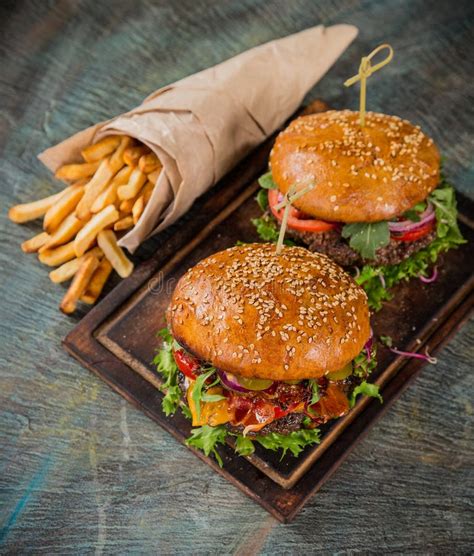Tasty Burgers On Wooden Table Stock Photo Image Of Dinner Delicious