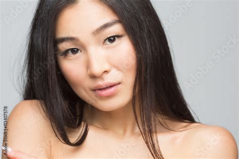 Closeup Picture Of Beautiful Woman Showing Her Beautiful Shoulders Isolated On Grey Happy