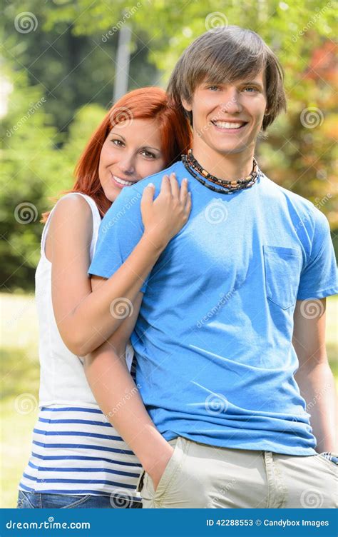 Teenage Girlfriend Embracing Her Boyfriend In Park Stock Image Image