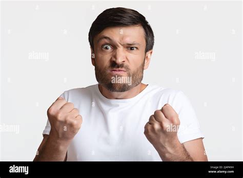Angry Man Clenching Fists Ready To Fight Over White Background Stock