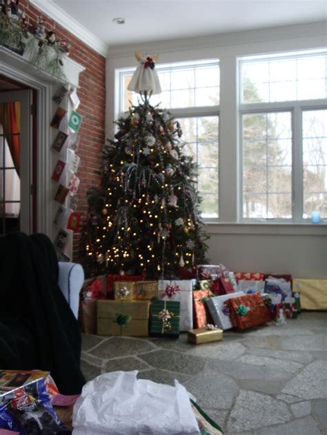A Living Room With A Christmas Tree And Presents On The Floor