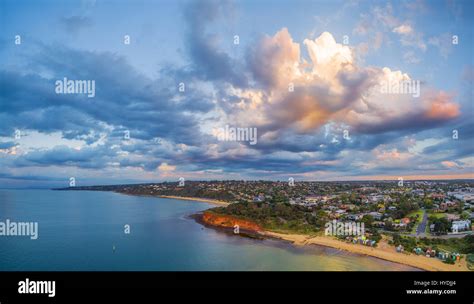 Aerial Panorama Of Coastline Beaches And Australian Suburban Area At Sunset With Beautiful