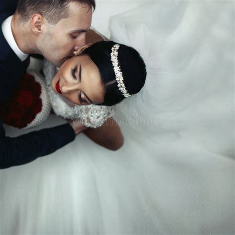 Romantic Groom Kissing Brunette Bride On The Neck Shot From Above
