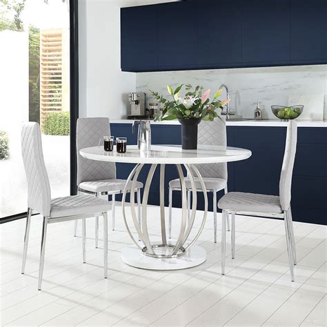 We ve paired our large white gloss dining tables with a variety of different chair combinations all of them thoughtfully selected to complement and flatter the high gloss. Savoy Round White High Gloss and Chrome Dining Table with ...