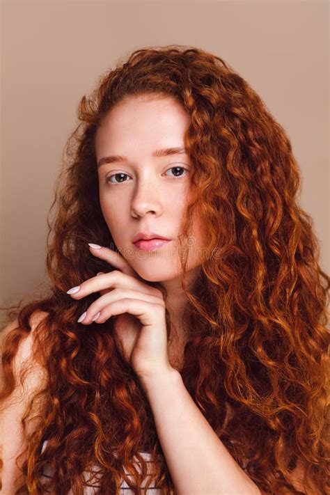 Portrait Of A Beautiful Red Haired Model With Long Curly Hair Brown