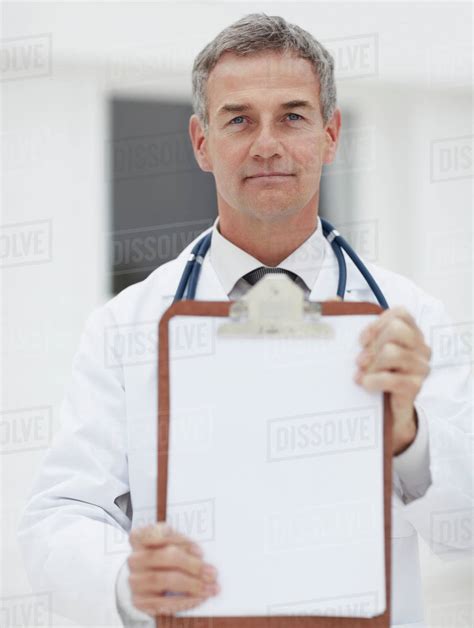 Doctor Holding Clipboard Stock Photo Dissolve