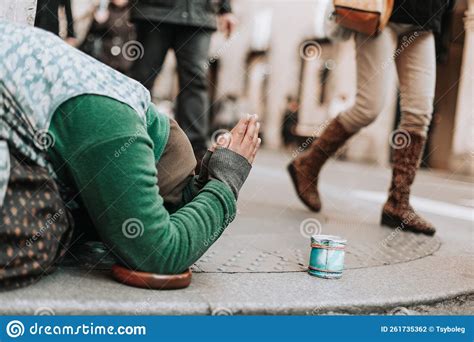 A Woman On Her Knees Begs For Alms On A City Street Editorial