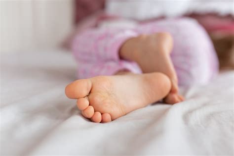 Premium Photo Feet Of A Girl Sleeping In A Comfortable Bed Focus On