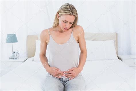 Blonde Suffering From Stomach Pain — Stock Photo © Wavebreakmedia 65556643