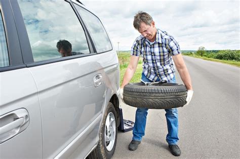 Premium Photo Man Changing A Spare Tire Of Car