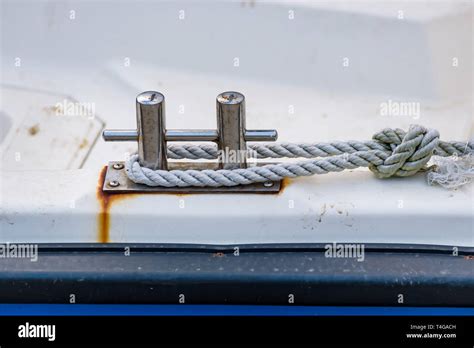 Close Up Of Boat Rope Tied To Nautical Cleat Hitch On Boat Stock Photo
