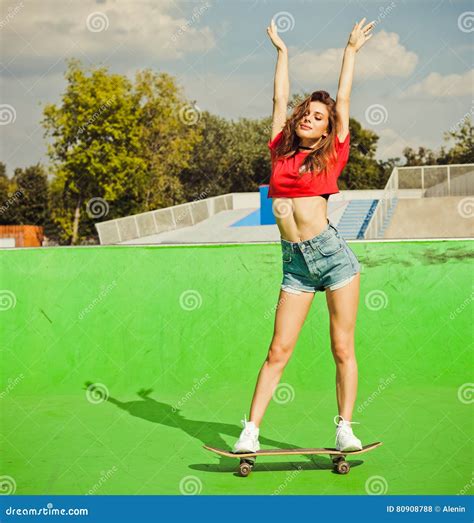 Beautiful Brunette Girl Posing On The Ramp Skate Park Standing On A