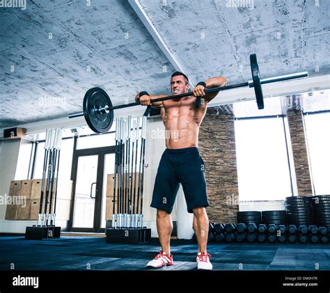 Muscular Man Lifting Barbell At Gym Stock Photo Alamy