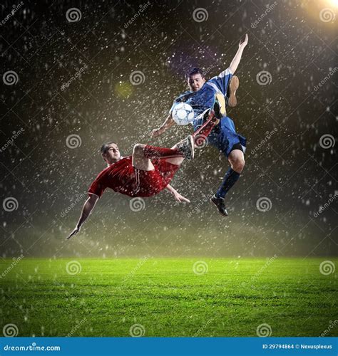 Two Football Players Striking The Ball Stock Photo Image Of Play