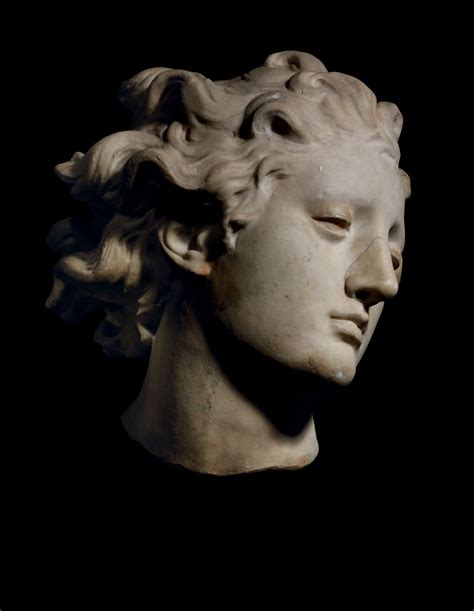 A Fragmentary Carved Marble Head Of A Youth Possibly St Michael