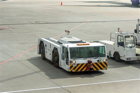 Towing Truck Pushing Back On The Parking Place At The Airport Stock