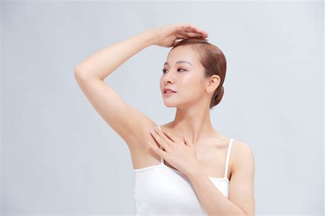 Beautiful Young Asian Woman Lifting Hands Up To Show Smooth Armpit