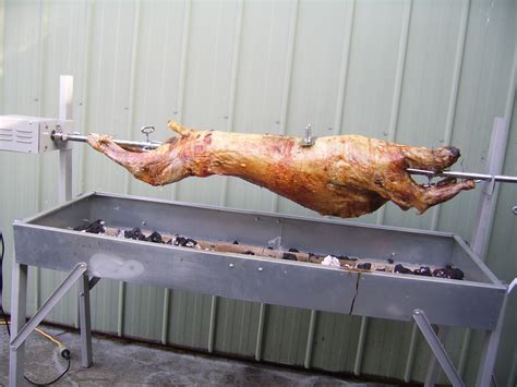 Outdoor Cooking With Charcoal Spit Roasted Meat