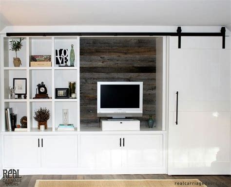 If the tv is hung on a fairly large wall (at least twice the width of the screen), then this sliding artwork could be a good way to hide the tv. Love this white shaker media cabinet with reclaimed wood ...
