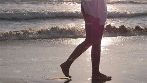 Woman Walking On Sandy Beach Near The Ocean Young Beautiful Girl