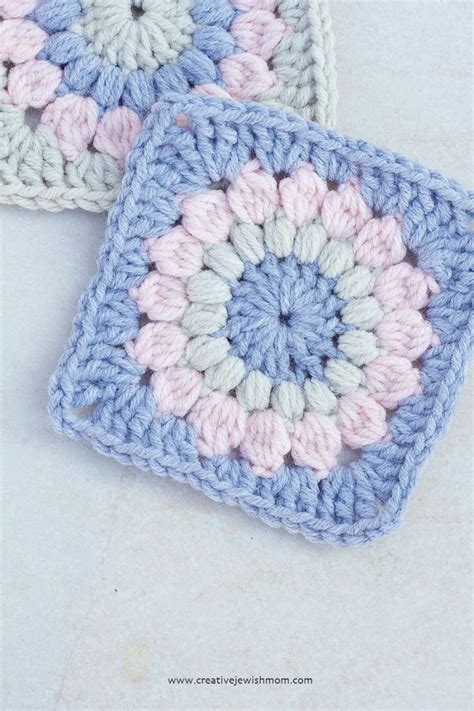 Two Square Crocheted Coasters Sitting Next To Each Other