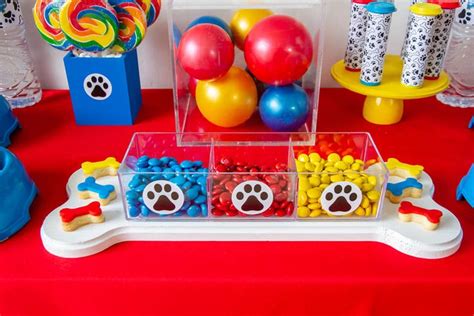 A Table Topped With Lots Of Colorful Candies Next To Balloons And Other