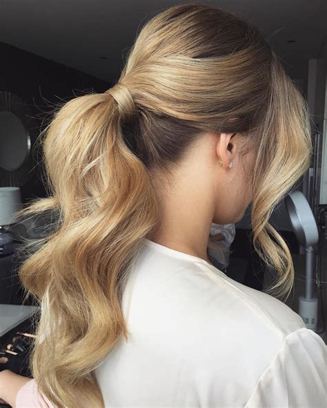 A Woman With Long Blonde Hair In A Ponytail