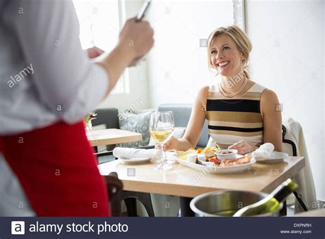 Waitress Serving Woman At Table In Bistro Stock Photo Alamy